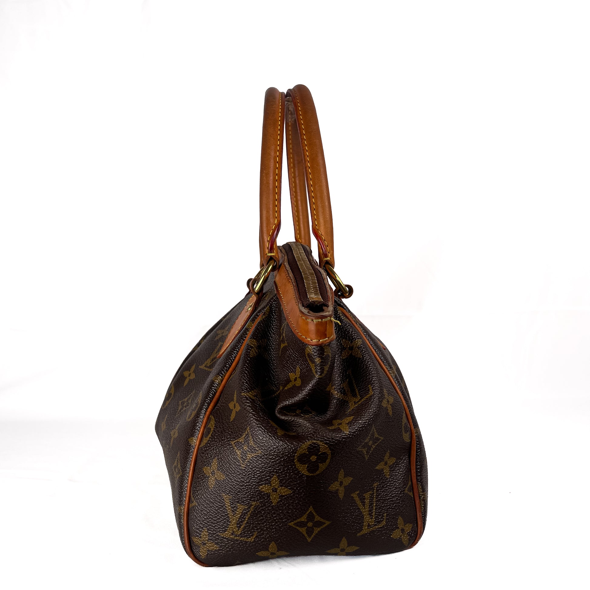 A Louis Vuitton monogram canvas handbag with tan leather trim and double top handles, shown from the back against a plain white background.
