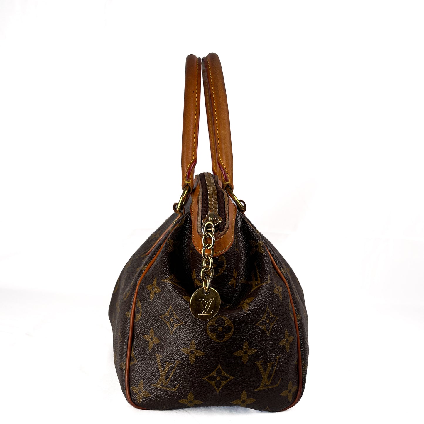 Louis Vuitton monogram canvas Speedy handbag in dark brown with tan leather handles and trim, featuring gold-tone hardware and a hanging LV logo charm, photographed against a plain white background.