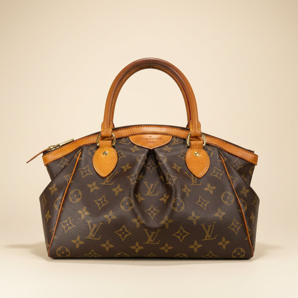 Louis Vuitton monogram canvas handbag with tan leather handles and trim, shown on a plain white background.