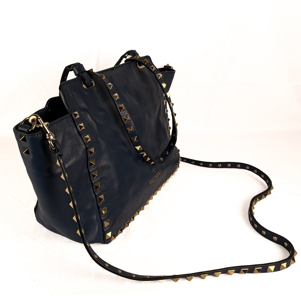 Side view of blue Valentino Garavani Rockstud leather tote